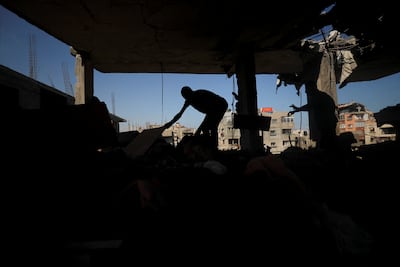 A Palestinian inspects the site of an overnight Israeli strike on a house in Gaza City on July 13, 2025. Reuters
