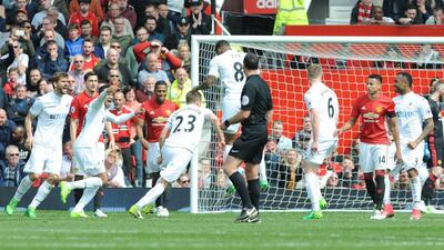 Swansea City, in white, are battling to avoid relegation. Rui Vieira / EPA