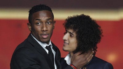 Ahmed Khalil, left, embraces UAE teammate Omar Abdulrahman after being named the AFC Asian Player of the Year. Altaf Qadri / AP Photo