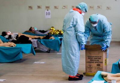 Patients in one of the emergency buildings set up to ease procedures at the Brescia hospital in northern Italy on Thursday, March 12, 2020 AP