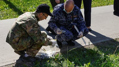 Investigators gather evidence outside a damaged apartment block. Reuters