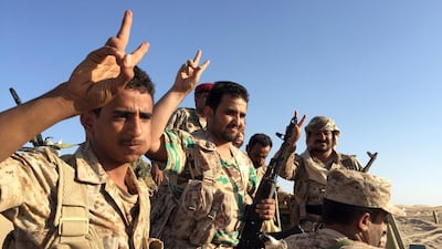 A group of soldiers trained by Emirati and Gulf Arab forces flash the victory sign near a military base in Marib province. Yemeni troops and Gulf special forces have captured several areas around Sirwah district in Marib since a military offensive in the province began on Sunday. Noah Browning / Reuters