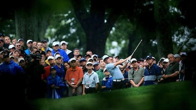 Rory McIlroy of Northern Ireland hits his second shot on the 12th hole as a gallery of patrons look on during the second round of the 96th PGA Championship at Valhalla Golf Club on August 8, 2014 in Louisville, Kentucky. David Cannon/Getty Images/AFP