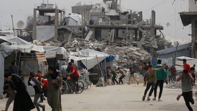 Palestinians run for cover as Israeli strikes hit Jabalia, in northern Gaza. AFP