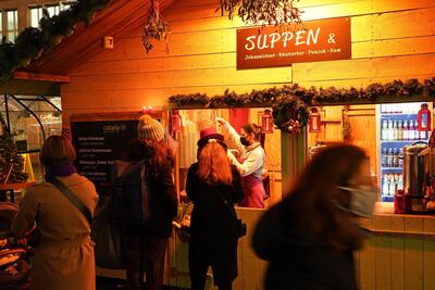 People line up at a Christmas stall in Berlin during the second wave of the coronavirus crisis. Getty Images