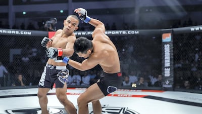 Rolando Dy lands a left hook on Lee Do-gyeom. Victor Besa/The National