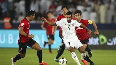Ali Mabkhout of Al-Jazira and Tomoaki Makino of Urawa Red Diamonds during the FIFA Club World Cup match between Al Jazira and Urawa Red Diamonds at Zayed Sports City Stadium on December 9, 2017 in Abu Dhabi, United Arab Emirates. (Photo by Francois Nel/Getty Images )