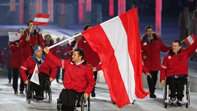 Team Austria with flag bearer Philipp Bonadimann enter the arena at the opening ceremonies for the 2014 Winter Paralympic Games on Friday. Sergei Chirikov / EPA / March 7, 2014