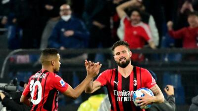 AC Milan French forward Olivier Giroud celebrates with teammate Brahim Diaz after scoring. AFP