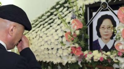 Bang Young-min, husband of Park Wang-ja, who was shot and killed at a mountain resort in North Korea, cries in front of Park's portrait during her funeral service at a hospital in Seoul.