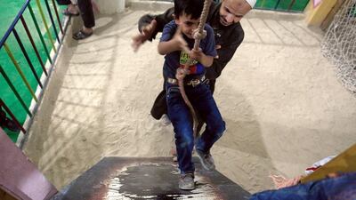 Syrian children play in an underground playground built to protect them from shelling in the rebel-held town of Erbin, east of the capital Damascus.