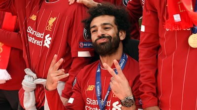 Liverpool's Egyptian midfielder Mohamed Salah gestures to the fans during an open-top bus parade around Liverpoo. AFP
