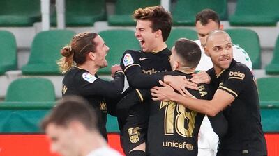 Barcelona's midfielder Riqui Puig, centre, celebrates his goal against Elche at the Martinez Valero Stadium on Sunday. AFP