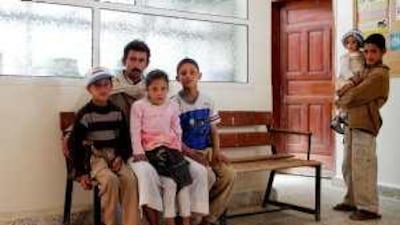 Yaya Salama, his children and, far right, niece and nephew depend on rations for sustenance.