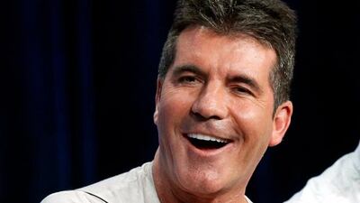 Judge Simon Cowell speaks at a panel for the television series "The X Factor" during the Fox portion of the Television Critics Association Summer press tour in Beverly Hills, California, in this file picture taken August 1, 2013. Cowell, the acerbic judge on "The X Factor" talent show, tied for first place as the highest-paid personality on U.S. television with "America's Got Talent" judge Howard Stern, Forbes.com said on August 8, 2013. Cowell, 53, jumped from third place last year, while Stern moved up from No. 2. Both earned an estimated $95 million for the year up to June 2013. REUTERS/Mario Anzuoni/Files (UNITED STATES - Tags: ENTERTAINMENT)