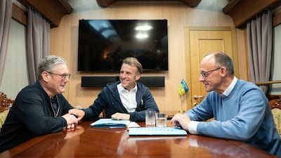 Mr Starmer meets with Mr Macron and German Chancellor Friedrich Merz onboard a train to the Ukrainian capital Kyiv in May 2025. Getty Images
