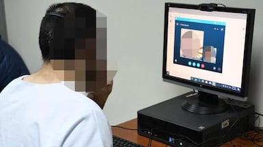 A prisoner speaks to a loved one through video call. Photo: Dubai Police.