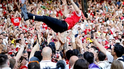 Arsenal manager Mikel Arteta is hoisted by his team. EPA