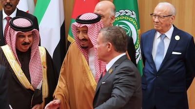 Jordan’s King Abdullah II, second from right, talking to Saudi Arabia’s King Salman, with Tunisian president Beji Caid Essebsi, right, standing behind them. Khalil Mazraawi / AFP