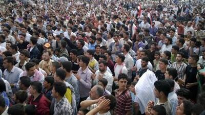 Syrian anti-regime protesters carry national flags during a rally in Talbiseh, in the central province of Homs, Syria. where armed residents have been fighting back against the Syrian army.