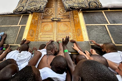 Worshippers touch the Kaaba at the Grand Mosque in Makkah. AFP