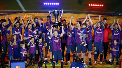 Barcelona's Andres Iniesta and team mates celebrate with the La Liga trophy after the match . Albert Gea / Reuters