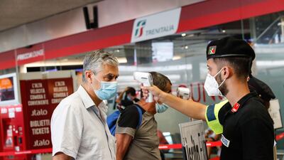 Passengers wearing protective masks at the Termini railway station during Phase 3 of the emergency for the coronavirus, in Rome, Italy, on August 23, 2020. EPA