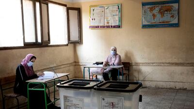 Election officials wait for people to vote on the first day of the Senate elections. AP Photo