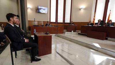 Barcelona football star Lionel Messi, left, and his father Jorge Horacio Messi listen as they face judges in a tax fraud case at the courthouse of Barcelona on June 2, 2016. Alberto Estevez / Reuters