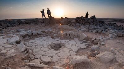 The charred remains of 14,500-year-old bread were found in the fireplace, centre, of a stone structure at an archaeological site in Jordan's Black Desert. Alexis Pantos via Reuters