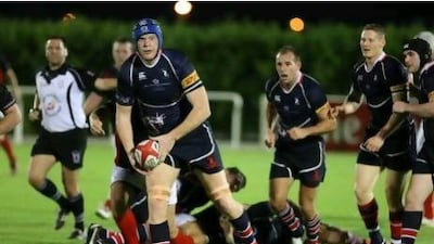 Jebel Ali Dragons, in their dark blue outfits, thrashed Dubai Exiles 56-9 on Friday to clinch a spot in the Grand Final. Pawan Singh / The National