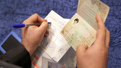 A poll worker checks the ID of Iran's Supreme Leader Ayatollah Ali Khamenei who has arrived to cast his vote at a polling station during parliamentary elections in Tehran, Iran. Reuters