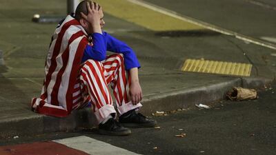 A man sits on the curb during a protest against president-elect Donald Trump in Seattle's Capitol Hill neighbourhood. Ted Warren / AP Photo