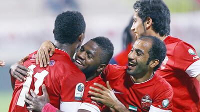 Al Ahli players congratulate Ahmed Khalil after his opener against Al Shaab. Satish Kumar / The National