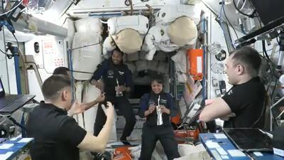 UAE's Sultan Al Neyadi offers dates and water to the two Saudi astronauts after their arrival