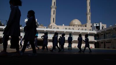Palestinian elementary school students enter school amid the coronavirus pandemic on the first day of class at United Nations-run school in the West Bank city of Ramallah. AP