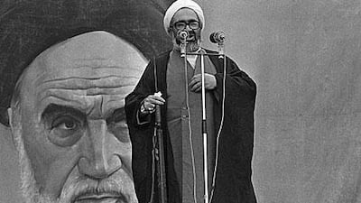 Grand Ayatollah Hossein Ali Montazeri holds a rifle during an address on November 23, 1979 at Tehran University.