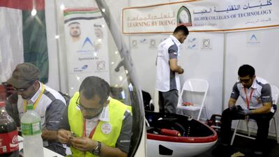 A team from the Higher Colleges of Technology finetune their vehicle before the start of the race. Jes Aznar for The National
