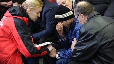 A Russian Emergency Situations Ministry employee tries to comfort a relative of the plane crash victims at the Rostov-on-Don airport. FlyDubai has said it will provide hardship payments to victims' families. AP Photo