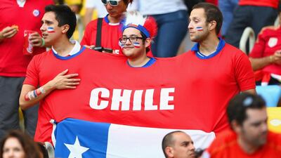 Chile fans look on, wearing a giant t-shirt flag, during their team's match against Spain on Wednesday at the 2014 World Cup in Rio de Janeiro, Brazil. Jamie Squire / Getty Images