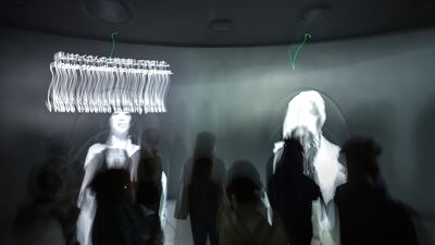 Visitors pick different paths to follow in the pavilion and learn from experiences of women around the world. Victor Besa / The National