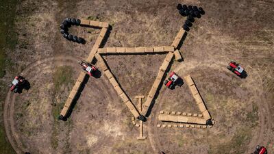 Aerial view shows tractors and straw bales forming a bike-shaped land art sculpture along the route of the third stage of the Tour de France cycling race, in Jutland, Denmark. AFP