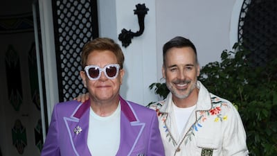 Elton John, in a lilac suit, and David Furnish attend the Midsummer Party to raise funds for the Elton John Aids Foundation in Antibes, France on July 24, 2019. Getty Images