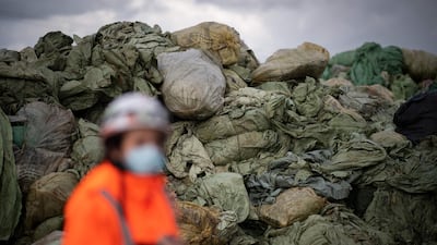 A Suez RV employee walks by piles of agricultural and industrial plastics collected to be recycled at the Suez RV recycling plant in Oree-d'Anjou, western France, on March 26. AFP