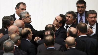 Turkish legislators from prime minister Recep Tayyip Erdogan's ruling party and the main opposition party brawl during a tense all-night debate over a controversial law on changes to a council that appoints and overseas judges and prosecutors, in Ankara on February 15, 2014. One legislator suffered a broken finger while another suffered a nose-bleed. Opposition parties say the bill would give the government wider controls over the council. AP