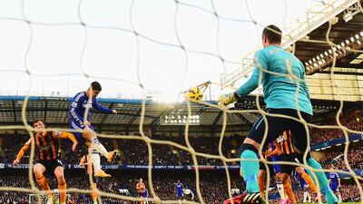 Eden Hazard of Chelsea heads the ball in for a goal past keeper Allan McGregor of Hull City in their Premier League match on Saturday. Jamie McDonald / Getty Images
