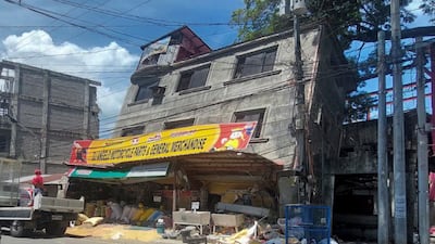 A building lies on its side in Bangued, Abra province, after the quake. AP