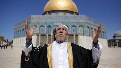 A Palestinian from Gaza City prays outside the Dome of the Rock during a visit to Al Aqsa mosque compound, Islam's third-holiest site, in Jerusalem's Old City. Ahmad Gharabli / AFP