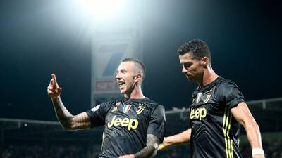 Federico Bernardeschi celebrates with Cristiano Ronaldo after scoring Juventus's second goal. AFP