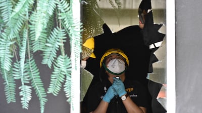 Forensics officers inspect the site in the aftermath of the blaze, the deadliest such incident in Thailand for almost two decades. AFP